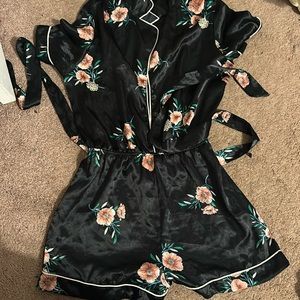 A black short set jumpsuit with pink flower print